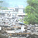 Locals walk across a makeshift bamboo and wooden crossing